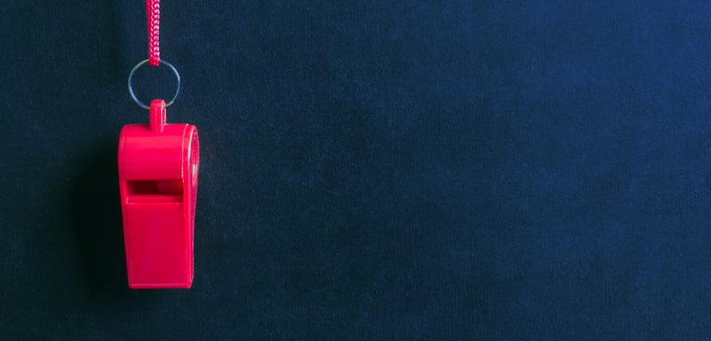 Red whistle on blue background